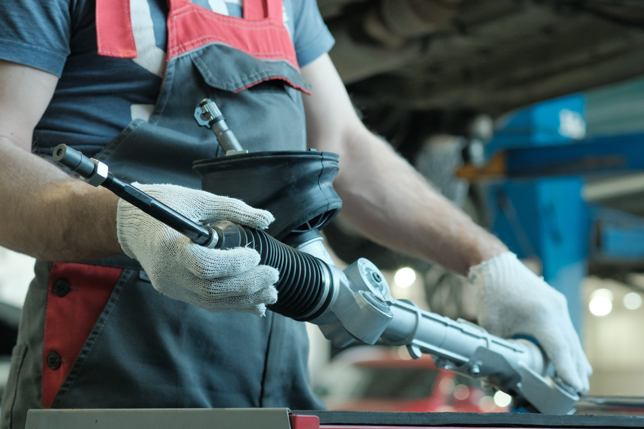 Technician repairing a vehicle power steering system in Edmonton