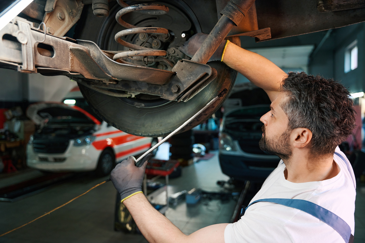 Mechanic inspecting a vehicle suspension system in Edmonton