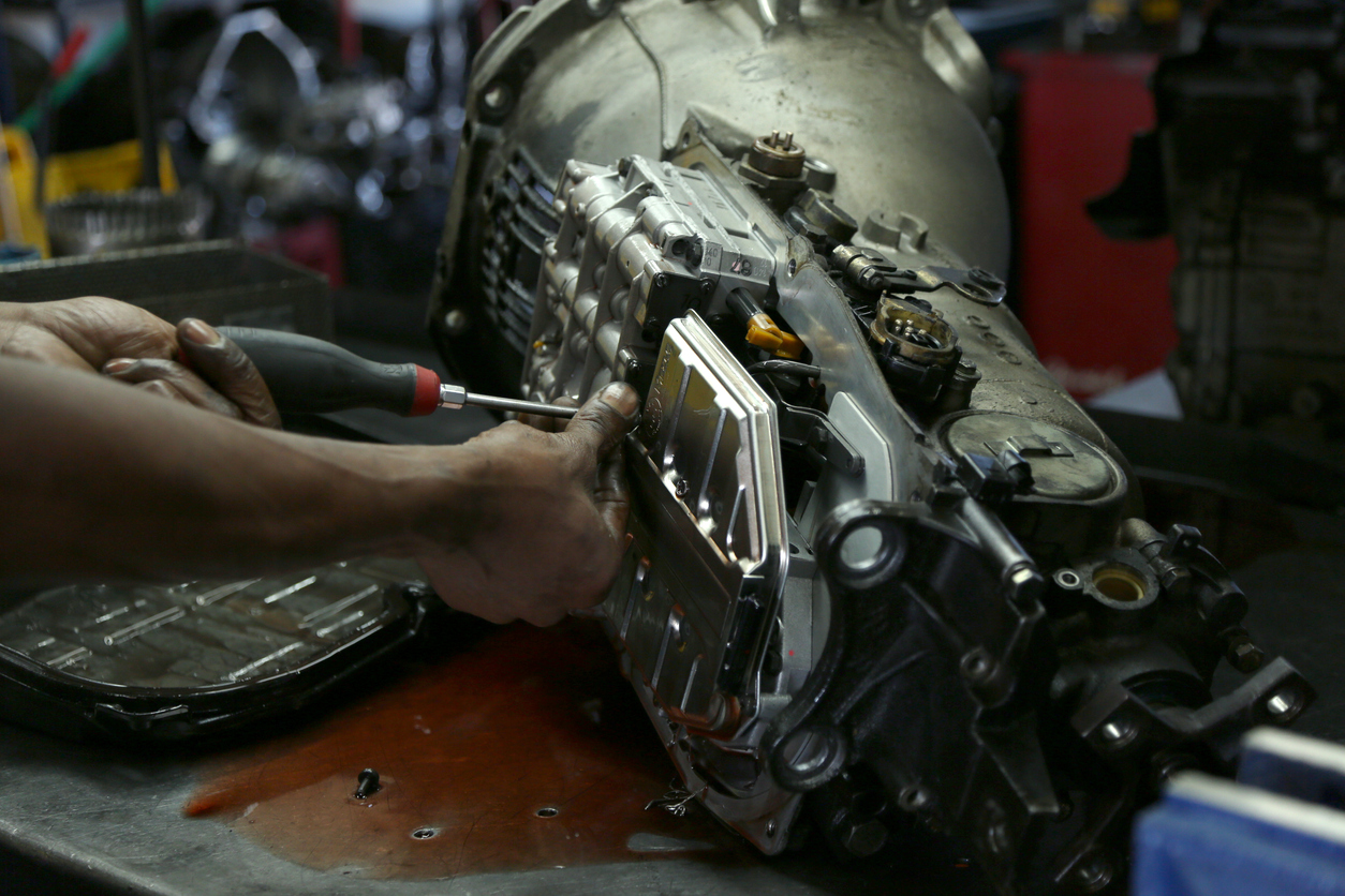 Mechanic performing transmission repair at an Edmonton automotive shop