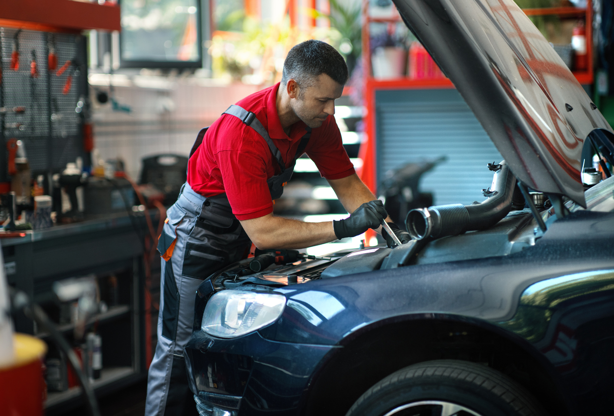 Technician performing engine repair at an Edmonton auto repair shop