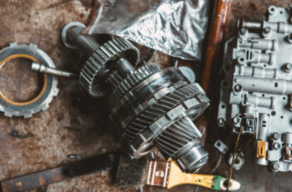 closeup vehicle gear clutch cog wheel metal part for repairing service engine overhaul process in garage