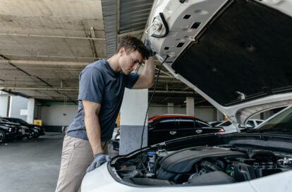 Mechanic inspecting engine at garage workshop, Car auto services and maintenance check concept.